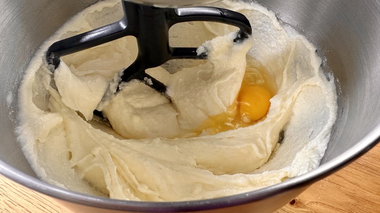 beating eggs into creamy mixture