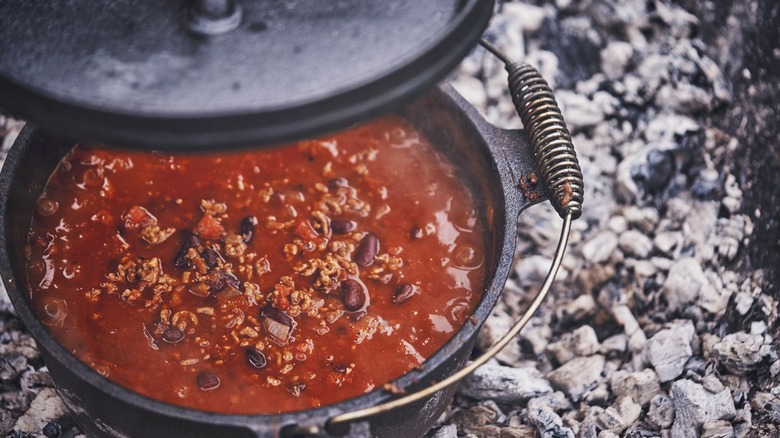 Chili cooking in a cast iron pot