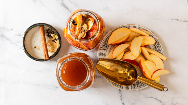 Jar with kombucha besides flavorings