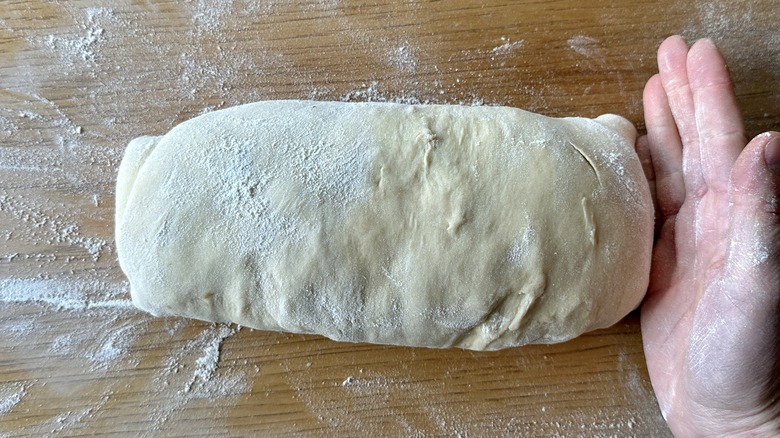 Pinching seams of dough to seal