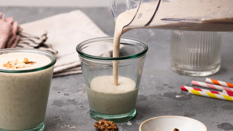 Pouring smoothie into a glass 