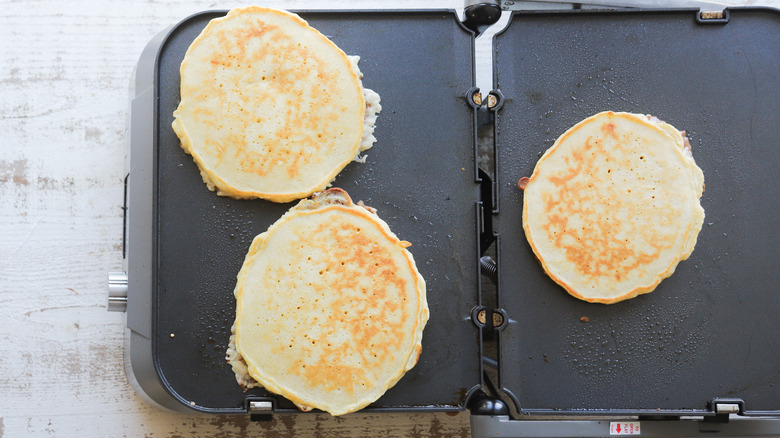 Pancakes cooking on nonstick griddle