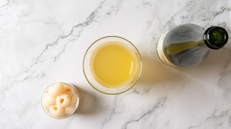 Pitcher with yellow sangria and sparkling wine