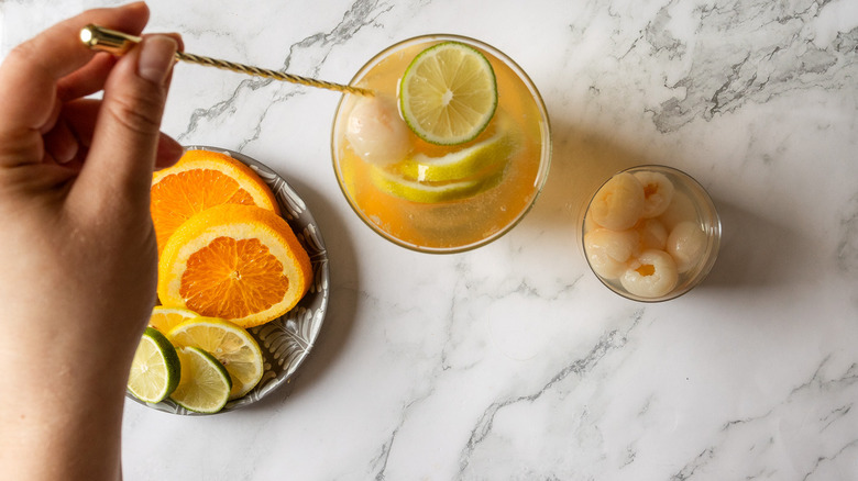 Hand stirring sangria pitcher