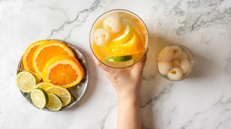 Hand holding sangria pitcher