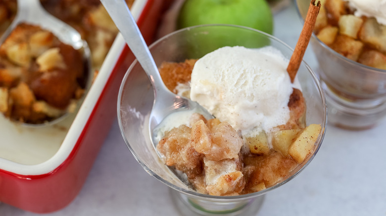 Spoon in a dish of apple brown betty