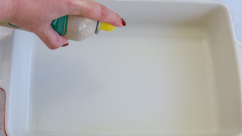 Baking pan being sprayed with nonstick spray