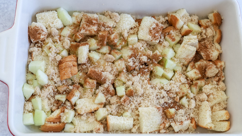 Cinnamon and brown sugar covering apples and bread cubes