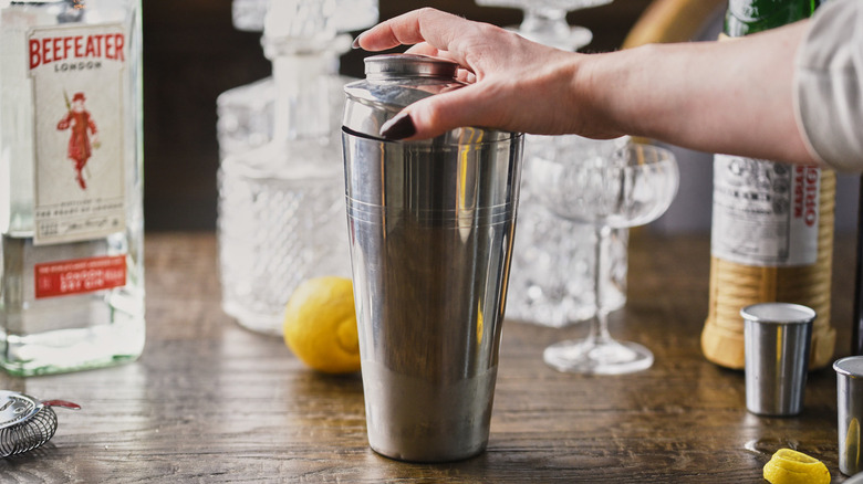 lidded cocktail shaker with hand