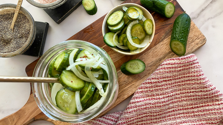 pickles in jar and bowl on board