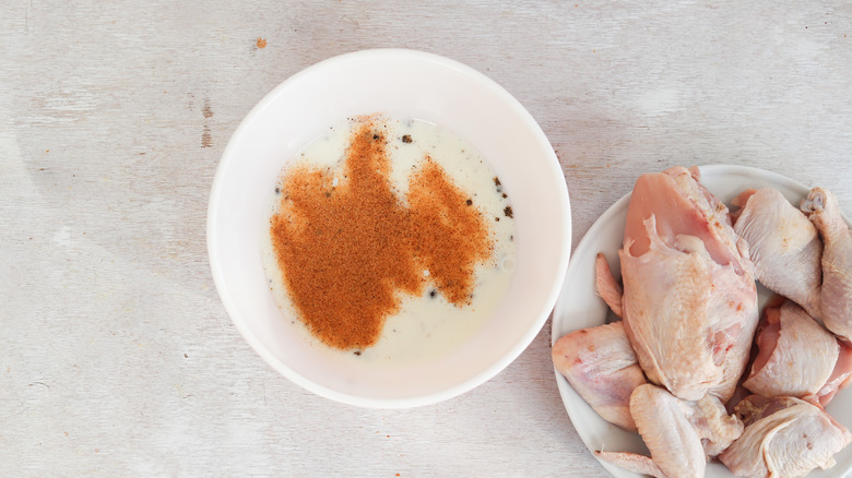 seasoned buttermilk in bowl next to chicken