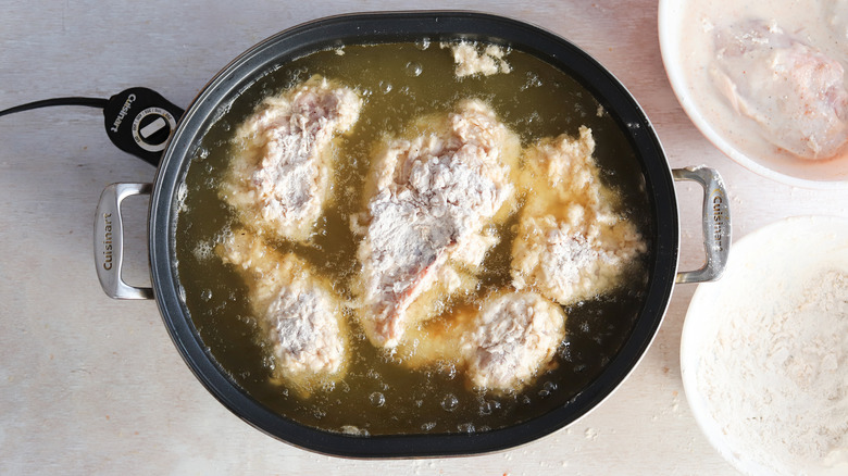 frying breaded chicken in oil