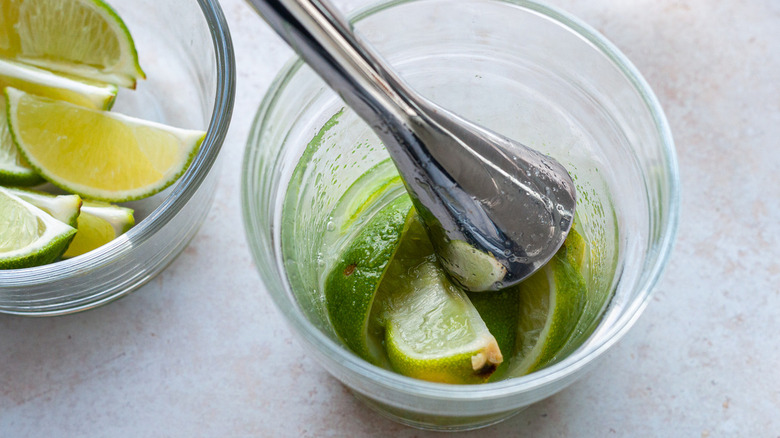 limes and sugar with muddler