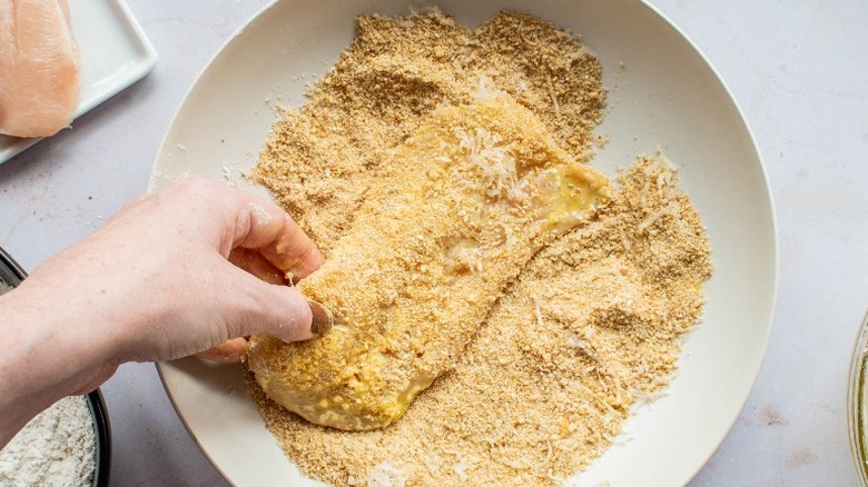 chicken cutlet covered with breadcrumbs in a bowl
