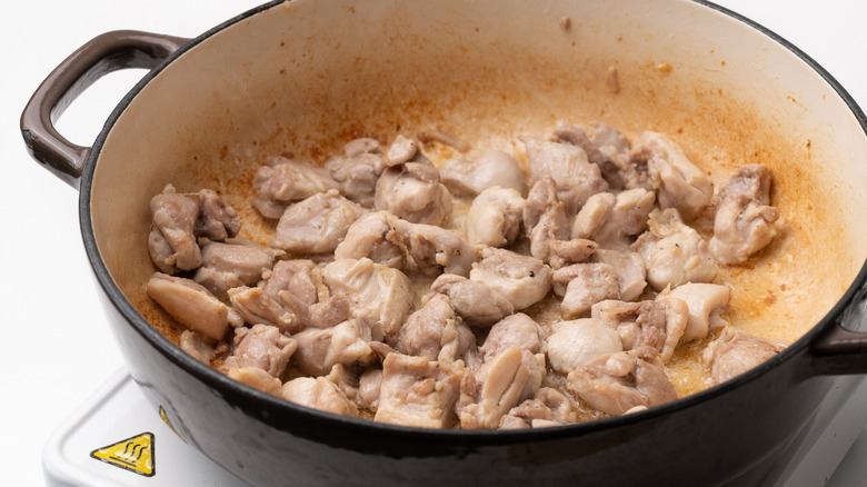 browning chicken in a pan 