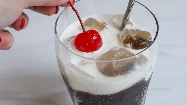 placing cherry onto creamy beverage