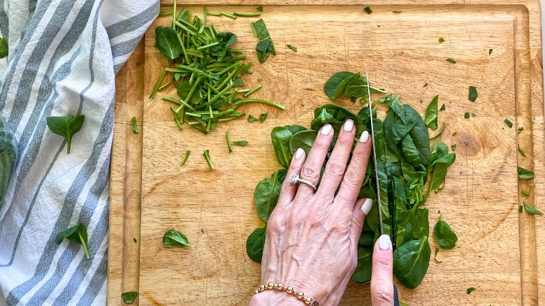 cutting spinach on board