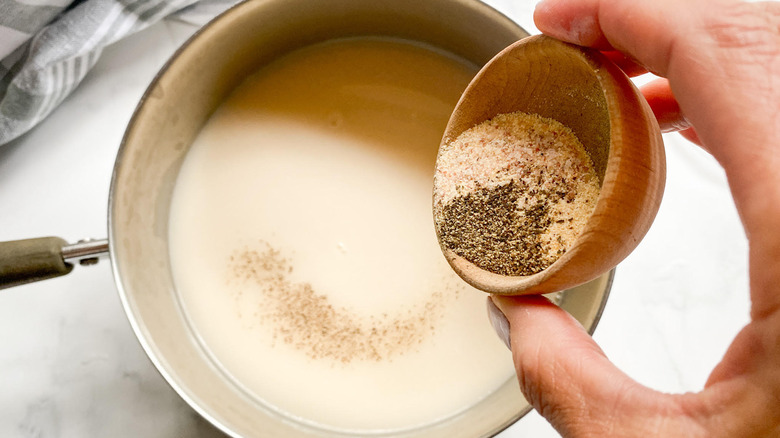 Milk and spices in pan 