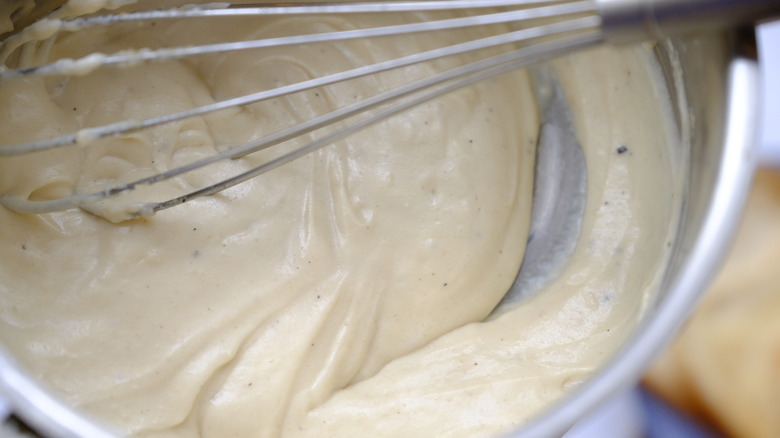 béchamel sauce and whisk