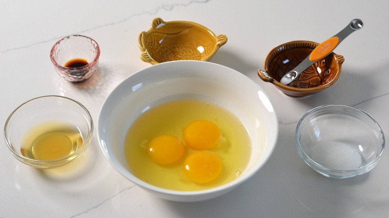 three cracked eggs in bowl