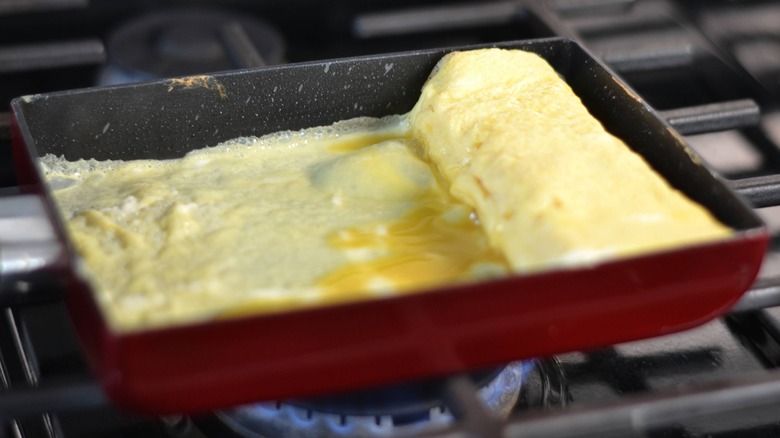 rolled egg and thin egg layer in pan