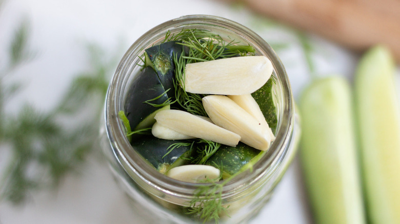 garlic and cucumbers in jar