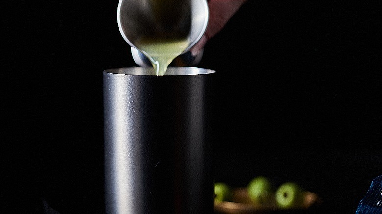 pouring pineapple juice into shaker