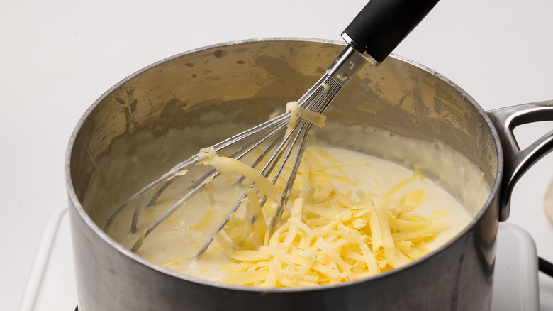 Mixing cheese into béchamel sauce