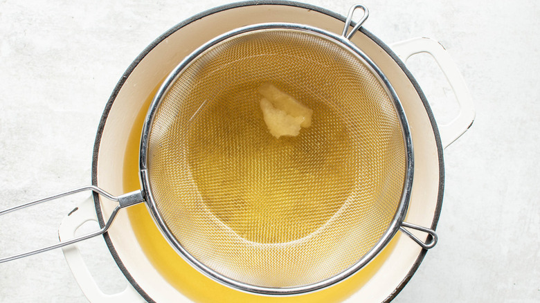 limoncello in pot with strainer