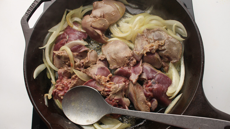 liver and onions cooking in a pan