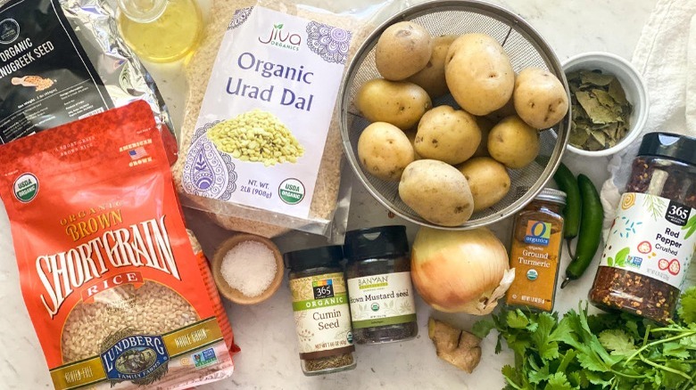 Ingredients for masala dosa: fenugreek seed, short grain rice, urad dal, oil, potatoes, chili, onion, garlic, seasonings, cilantro