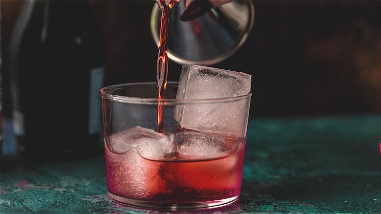 pouring campari into glass