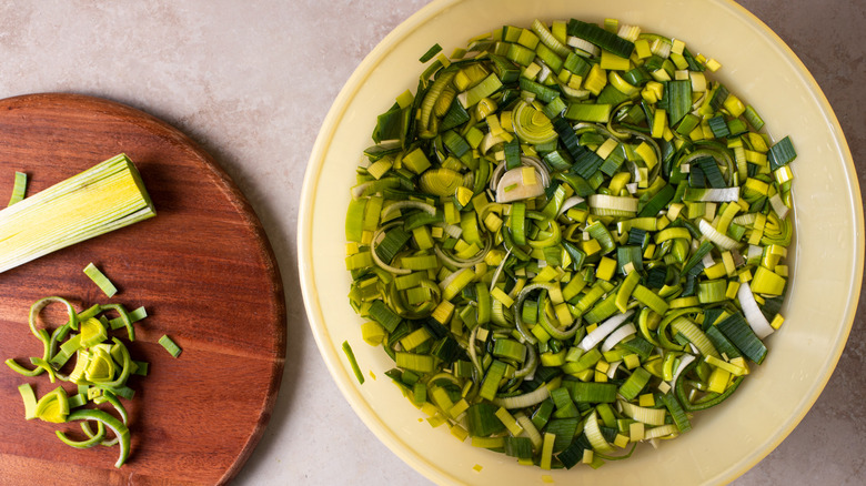 chopped leeks in a bowl of water