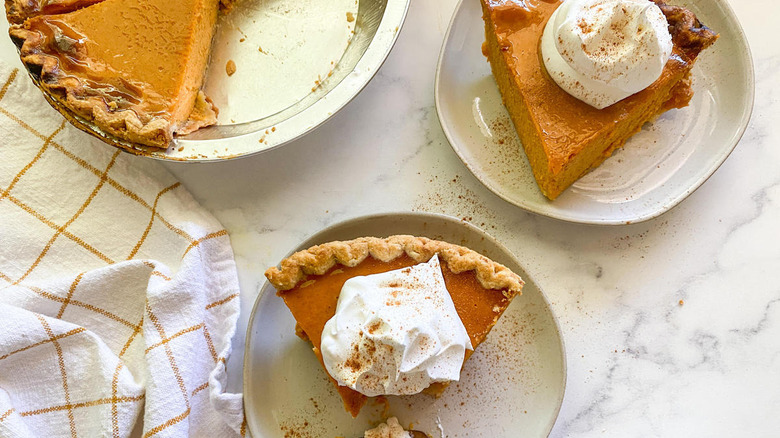 sliced pumpkin pie on plates