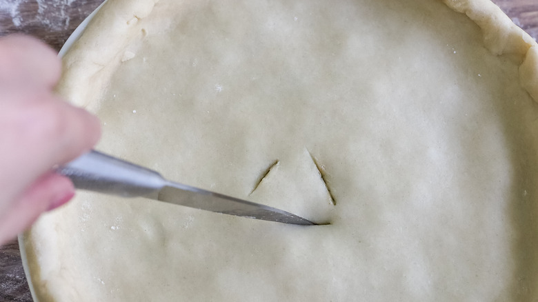 cutting slits on pie top