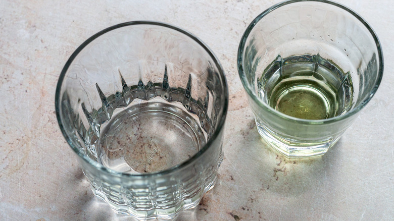 two glasses, one with absinthe