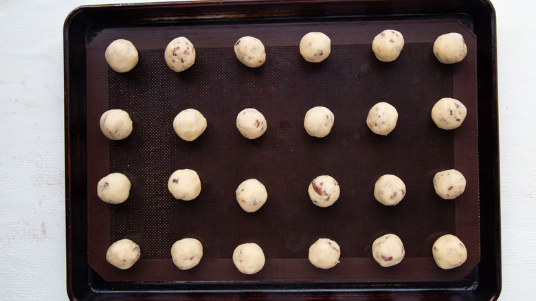 cookie balls on baking sheet