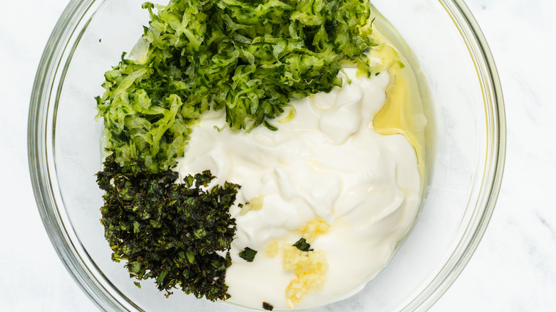 unmixed tzatziki ingredients in bowl