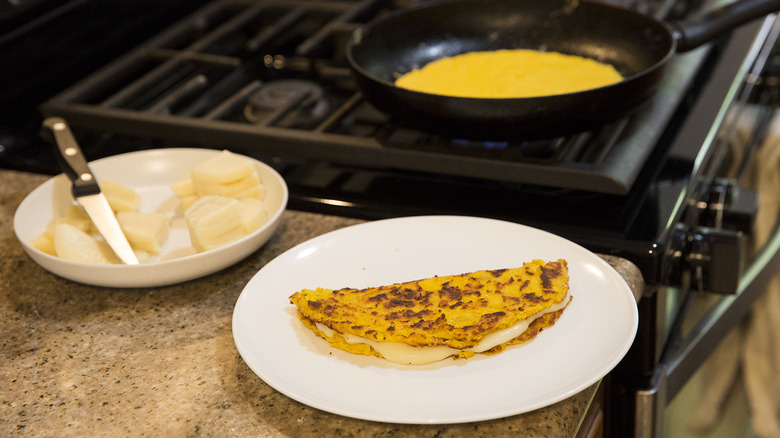 cachapa on plate by stove