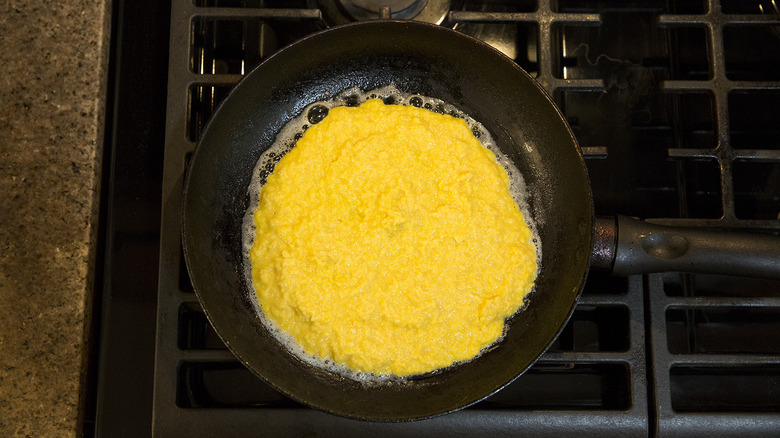 cachapa cooking in frying pan