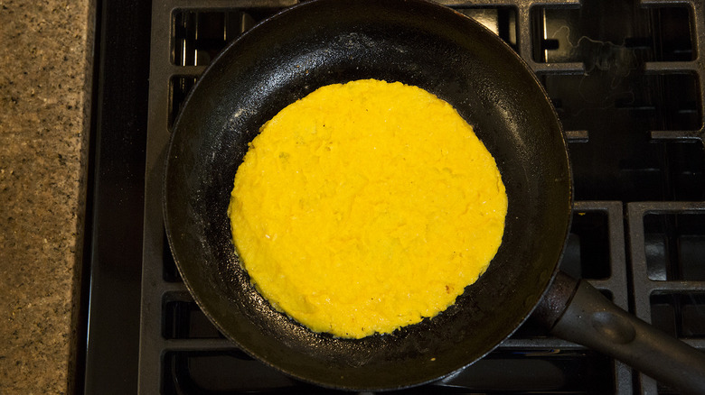 cachapa cooking in frying pan