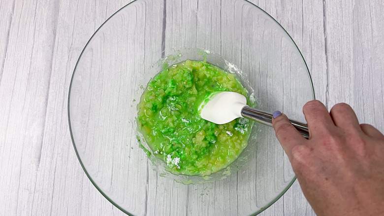 spatula mixing green crushed pineapple