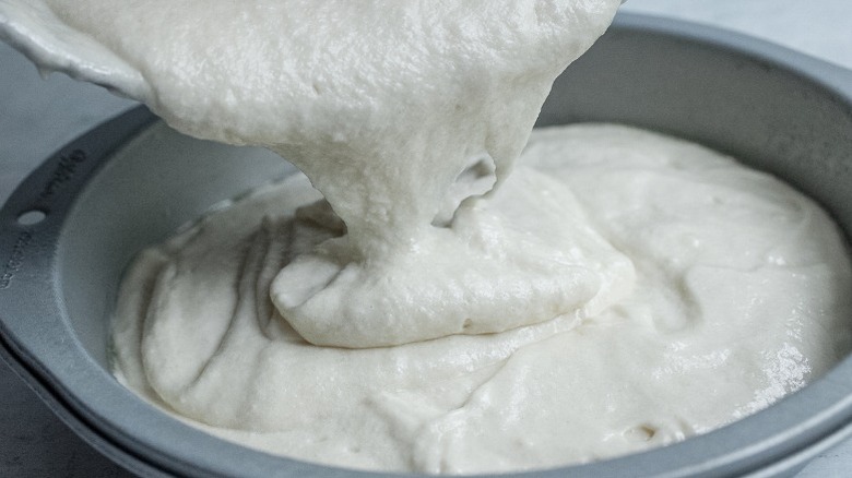 pouring cake batter into pan