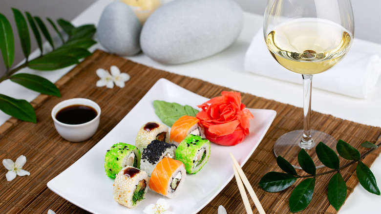 sushi and glass of white wine