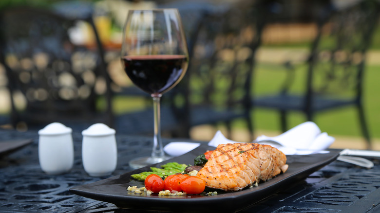 glass of red wine and grilled salmon