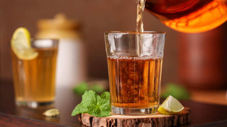 pouring cup of black tea