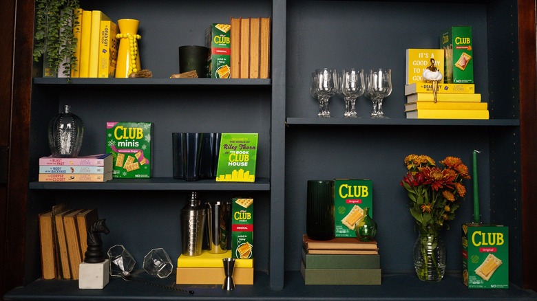 Club crackers on the shelf with books and wineglasses