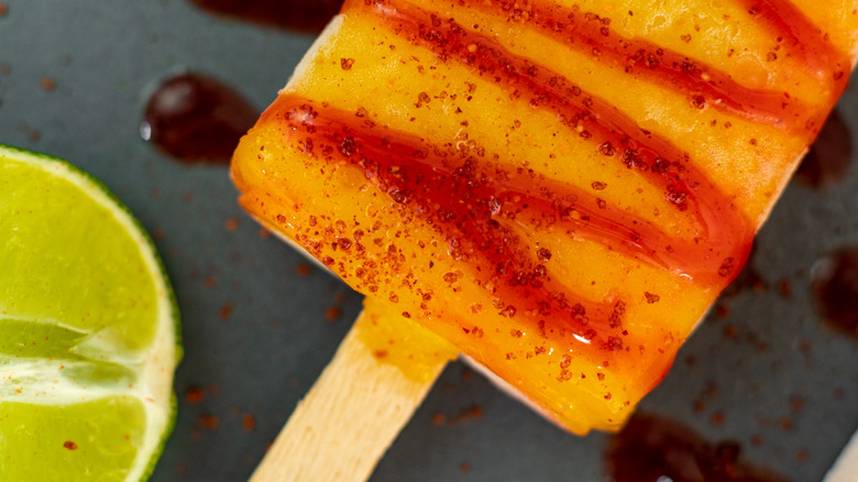 Mango popsicle coated in Tajin