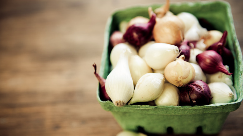 A carton of multicolored pearl onions