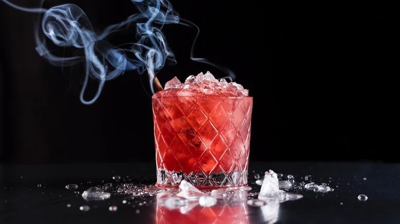 Bourbon-Blackberry Cocktail with smoking cinnamon stick